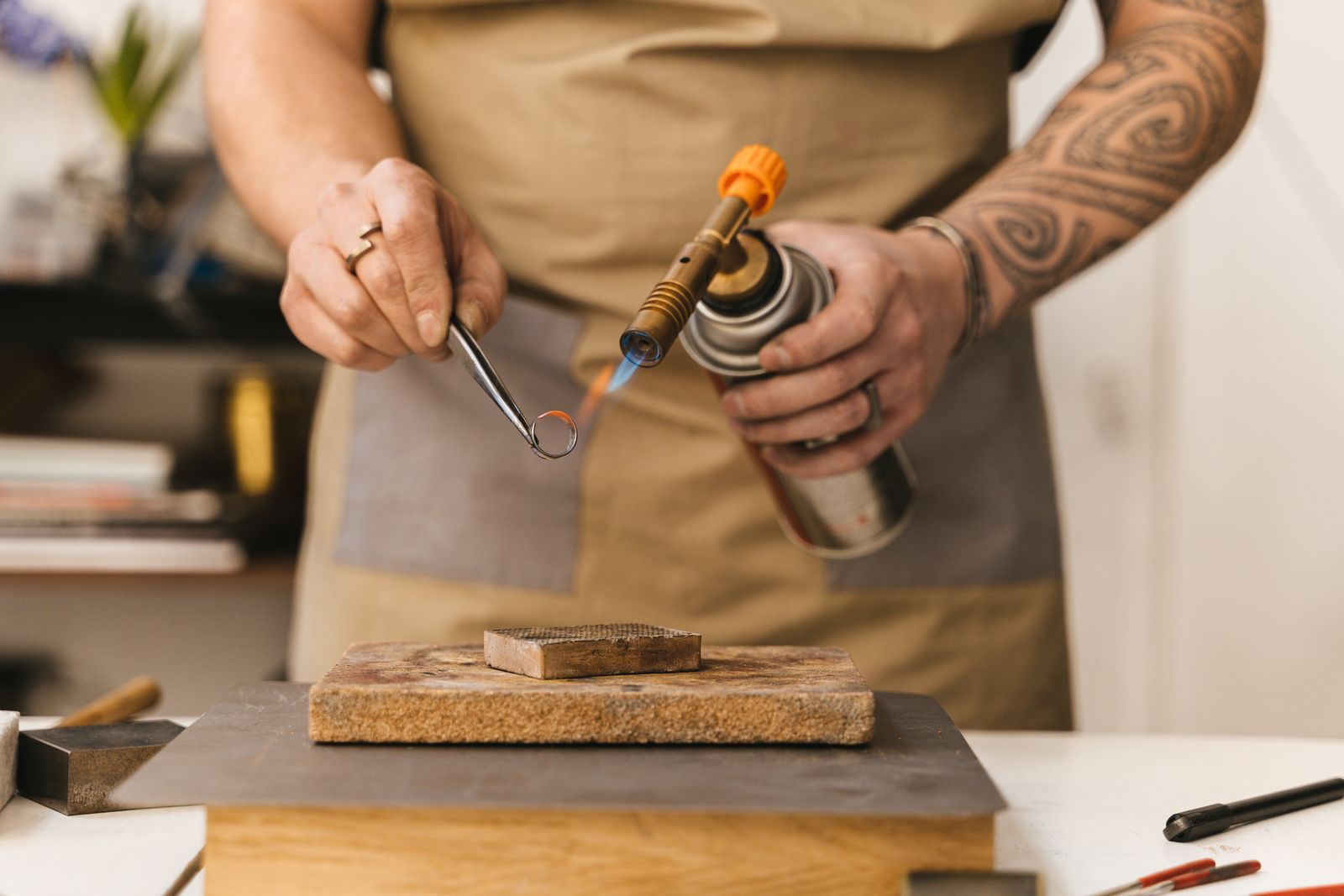 Jeweller crafting a ring with a torch